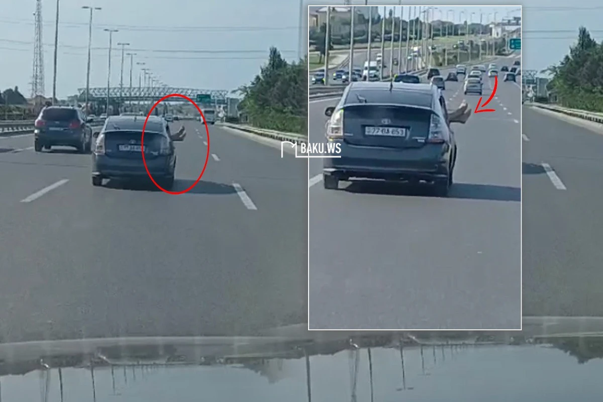 Пассажир высунул ноги из окна движущегося Приуса в Баку - ВИДЕО