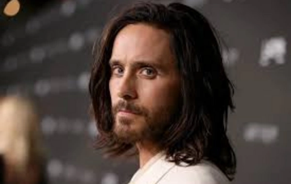Jared Leto bathed in icy water against the backdrop of snow-covered mountains